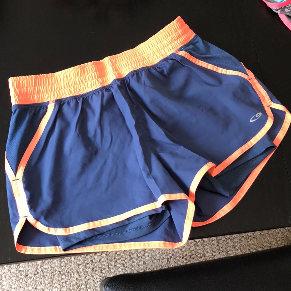 Blue and neon orange running shorts